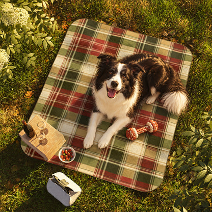 Border Collie lying on the TekPaws Evergreen Escape plaid picnic blanket
